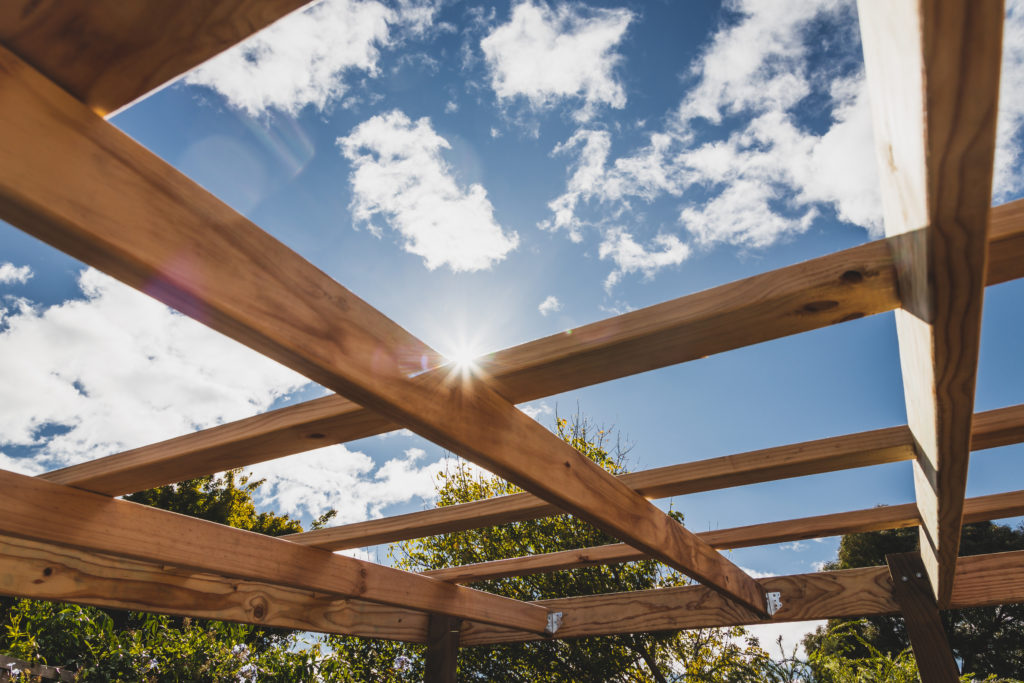 the roof of a wooden pergola patio without a cover 