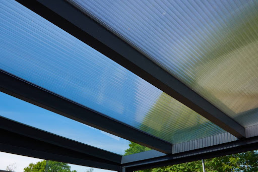 hail proof polycarbonate pergola cover on top of a metal pergola