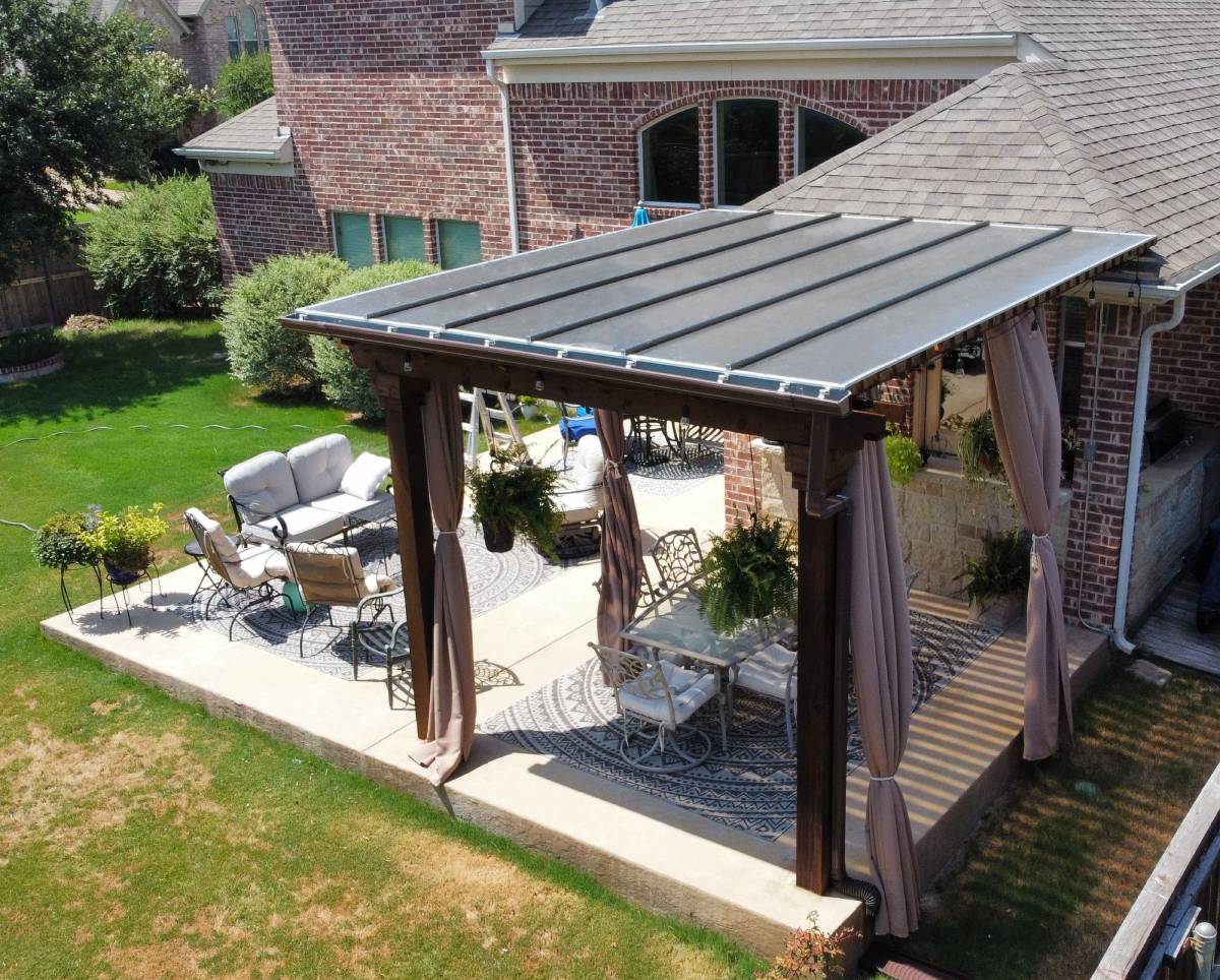 covered pergola over an outdoor dining area